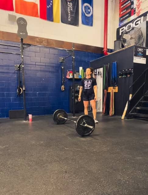 A member setting up for a deadlift on the studio platform